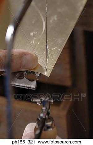 Close-up of a person's hands cutting metal sheet with a hacksaw blade View Large Photo Image Stock Image - Close-up of a person's hands cutting metal sheet with a hacksaw blade. Fotosearch