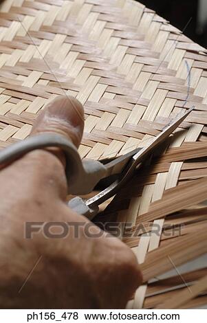 Stock Photo - Close-up of a person's hands cutting wooden strips. Fotosearch