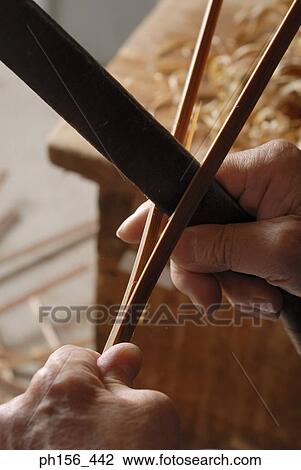 Close-up of a person's hands dividing a wooden stick View Large Photo Image Stock Image - Close-up of a person's hands dividing a wooden stick. Fotosearch