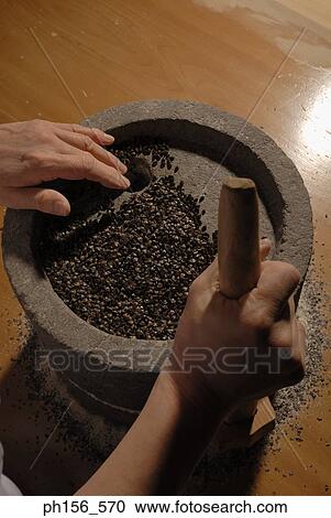 Stock Image - Close-up of a person's hands grinding on a grinding stone. Fotosearch