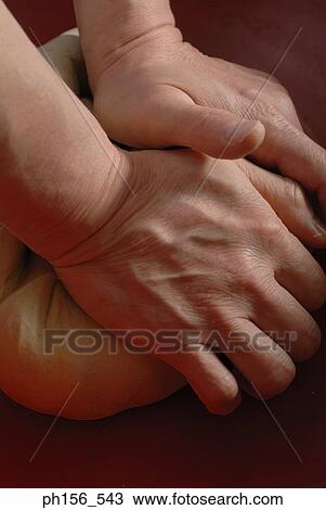 Stock Image - Close-up of a person's hands kneading dough. Fotosearch