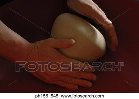Stock Photography - Close-up of a person's hands kneading dough. Fotosearch
