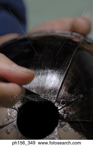 Stock Photo - Close-up of a person's hands making a helmet of armor. Fotosearch