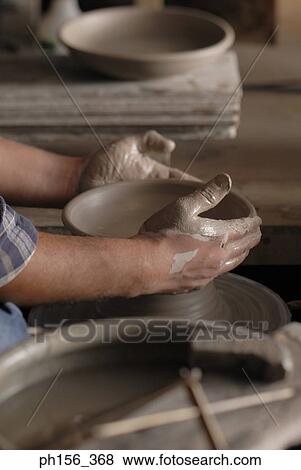 Close-up of a person's hands making pottery View Large Photo Image Stock Photo - Close-up of a person's hands making pottery. Fotosearch