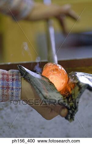 Close-up of a person's hands molding a glass bulb View Large Photo Image Stock Image - Close-up of a person's hands molding a glass bulb. Fotosearch
