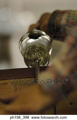 Stock Photo - Close-up of a person's hands molding a glass bulb. Fotosearch