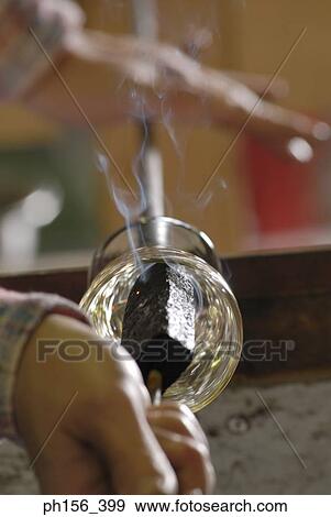 Close-up of a person's hands molding a glass bulb View Large Photo Image Stock Photo - Close-up of a person's hands molding a glass bulb. Fotosearch