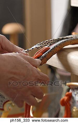 Close-up of a person's hands weaving ribbons View Large Photo Image Stock Image - Close-up of a person's hands weaving ribbons. Fotosearch