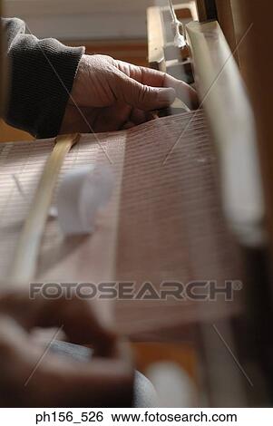 Close-up of a person's hands working on a loom View Large Photo Image Stock Photograph - Close-up of a person's hands working on a loom. Fotosearch