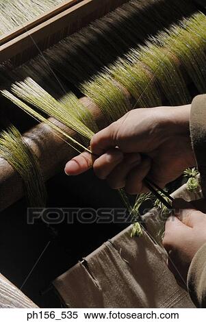 Close-up of a person's hands working on a loom View Large Photo Image Stock Photography - Close-up of a person's hands working on a loom. Fotosearch