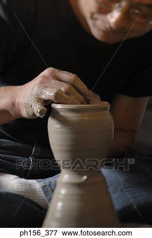 Stock Photo - Close-up of a potter making a vase. Fotosearch