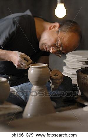 Stock Photo - Close-up of a potter making pottery. Fotosearch