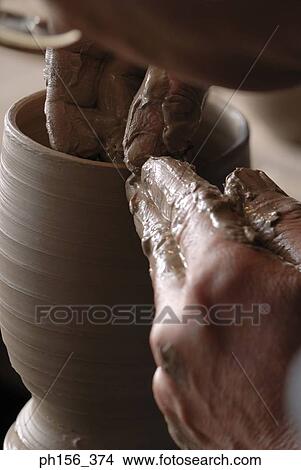 Picture - Close-up of a potter's hands making a vase. Fotosearch