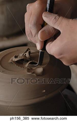 Stock Photography - Close-up of a potter's hands making a vase on a pottery wheel. Fotosearch