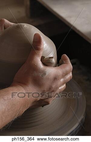 Close-up of a potter's hands making pottery View Large Photo Image Picture - Close-up of a potter's hands making pottery. Fotosearch