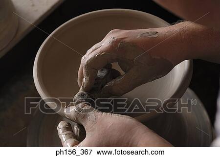 Close-up of a potter's hands making pottery View Large Photo Image Stock Photo - Close-up of a potter's hands making pottery. Fotosearch