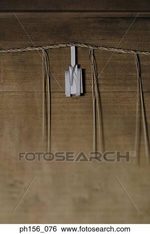 Stock Photograph - Close-up of a rope mounted against a wooden wall. Fotosearch