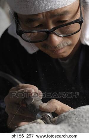 Close-up of a sculptor drilling a stone View Large Photo Image Stock Photo - Close-up of a sculptor drilling a stone. Fotosearch