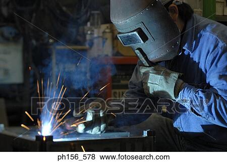 Stock Photo - Close-up of a welder welding. Fotosearch