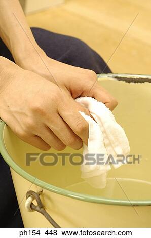 Close-up of a woman's hand squeezing a towel View Large Photo Image Stock Photo - Close-up of a woman's hand squeezing a towel. Fotosearch