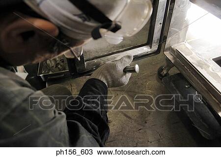 Stock Image - Close-up of a worker working in a workshop. Fotosearch