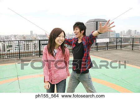 Close-up of a young couple standing on a terrace View Large Photo Image Picture - Close-up of a young couple standing on a terrace. Fotosearch