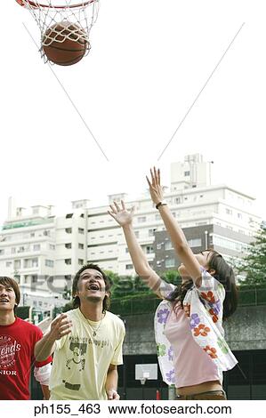 Close-up of a young woman shooting a basket ball into a hoop View Large Photo Image Stock Image - Close-up of a young woman shooting a basket ball into a hoop. Fotosearch