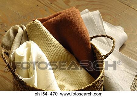 Stock Image - Close-up of clothes in a wicker basket. Fotosearch