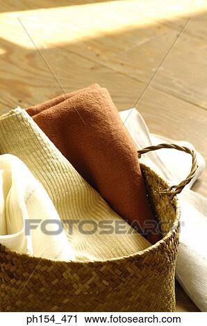 Close-up of clothes in a wicker basket View Large Photo Image Stock Image - Close-up of clothes in a wicker basket. Fotosearch