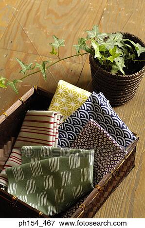 Close-up of fabric in a basket beside a potted plant View Large Photo Image Stock Photo - Close-up of fabric in a basket beside a potted plant. Fotosearch