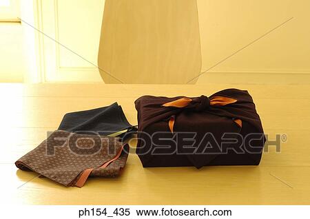 Stock Photography - Close-up of fabric next to a wrapped package. Fotosearch
