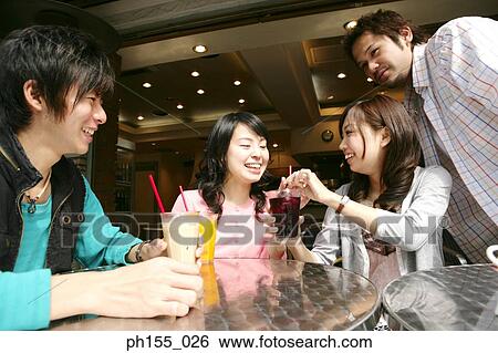 Close-up of four friends in a restaurant View Large Photo Image Stock Photograph - Close-up of four friends in a restaurant. Fotosearch