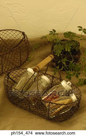 Picture - Close-up of jars of spices in a basket. Fotosearch