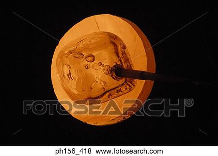 Close-up of molten glass at the end of a blow pipe in a furnace View Large Photo Image Stock Photo - Close-up of molten glass at the end of a blow pipe in a furnace. Fotosearch