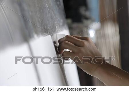 Close-up of person's hand sticking a sheet of paper on a board View Large Photo Image Stock Image - Close-up of person's hand sticking a sheet of paper on a board. Fotosearch
