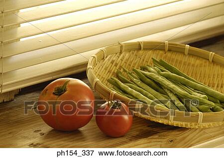 Stock Photo - Close-up of tomatoes with a bowl of beans. Fotosearch