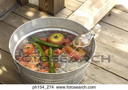 Picture - Close-up of vegetables and a water bottle in a washtub. Fotosearch