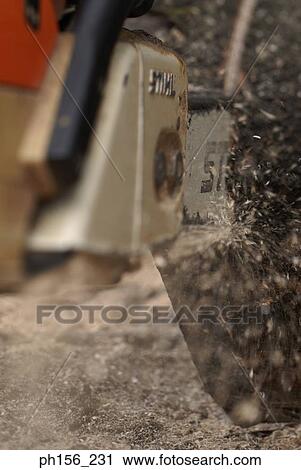 Stock Image - Close-up of wood getting cut in a lumberyard. Fotosearch