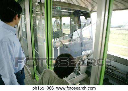 Father and his son looking at a train View Large Photo Image Stock Photograph - Father and his son looking at a train. Fotosearch