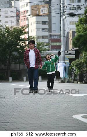 Father and his son walking side by side View Large Photo Image Stock Image - Father and his son walking side by side. Fotosearch