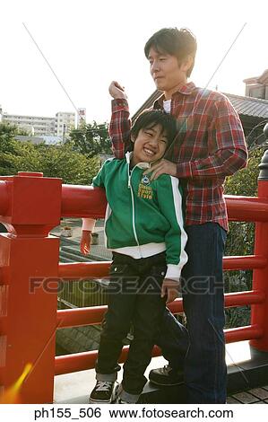 Stock Photograph - Father standing with his son. Fotosearch