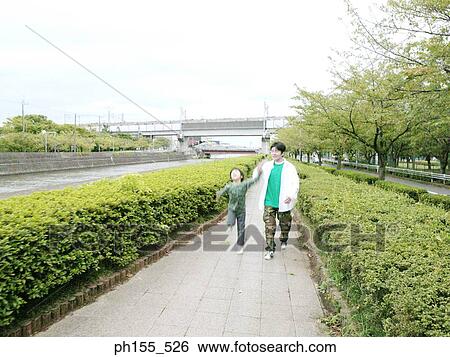 Father walking with his son View Large Photo Image Stock Photograph - Father walking with his son. Fotosearch