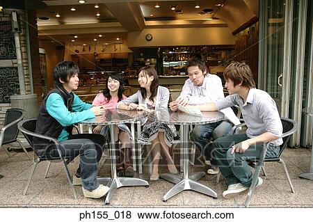 Five friends sitting in a restaurant View Large Photo Image Stock Photo - Five friends sitting in a restaurant. Fotosearch