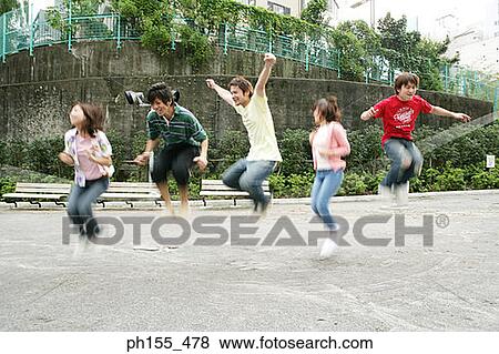 Five people jumping on a jump rope View Large Photo Image Stock Photo - Five people jumping on a jump rope. Fotosearch