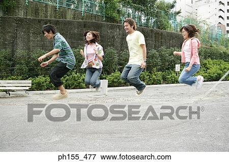 Four people jumping rope View Large Photo Image Stock Photo - Four people jumping rope. Fotosearch