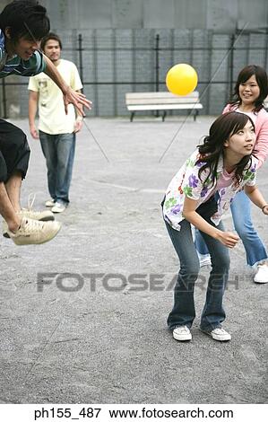 Four people playing with a ball View Large Photo Image Stock Photo - Four people playing with a ball. Fotosearch