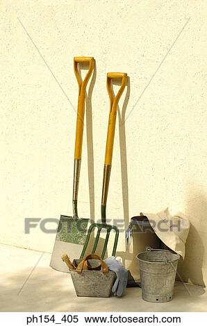 Stock Photography - Gardening equipment near a wall. Fotosearch