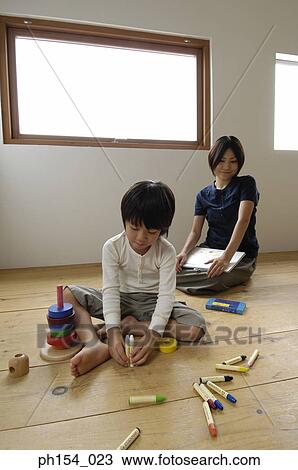 Girl playing with felt tip pens with her mother sitting behind her View Large Photo Image Stock Image - Girl playing with felt tip pens with her mother sitting behind her. Fotosearch