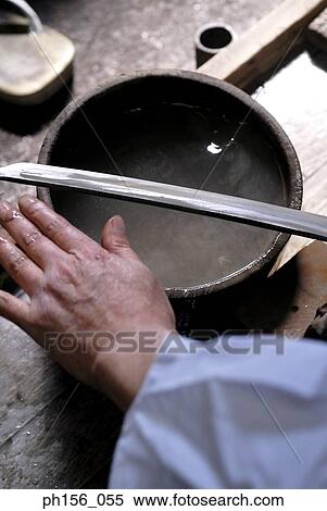 High angle view of a blacksmith's hand with a sword and a container View Large Photo Image Stock Photography - High angle view of a blacksmith's hand with a sword and a container. Fotosearch