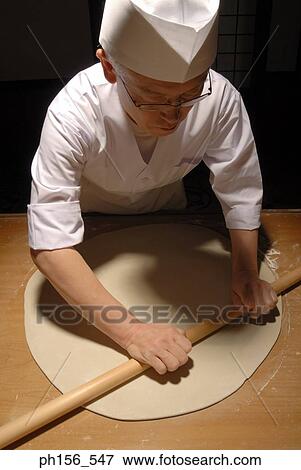 High angle view of a chef rolling dough View Large Photo Image Stock Photo - High angle view of a chef rolling dough. Fotosearch